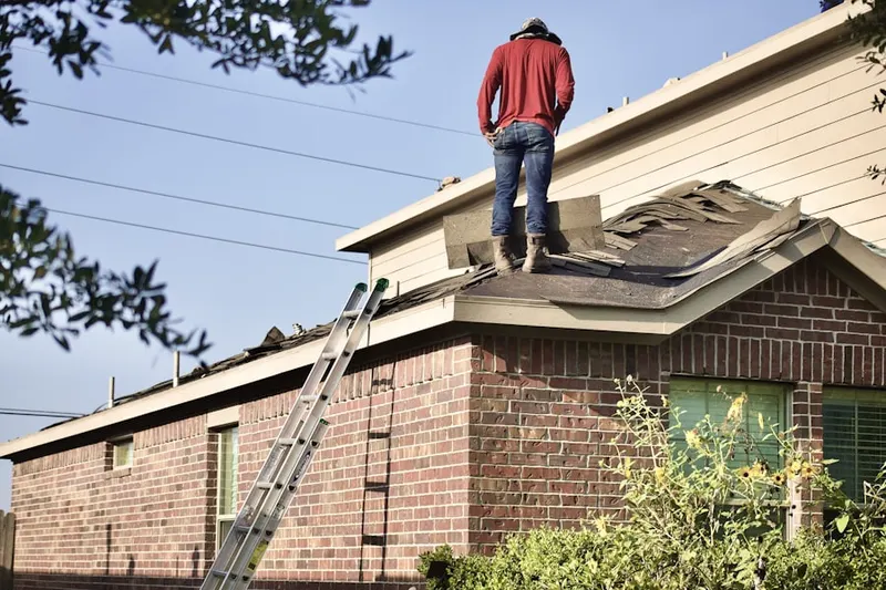Professional roofer working on a residential roof in Feasterville Trevose